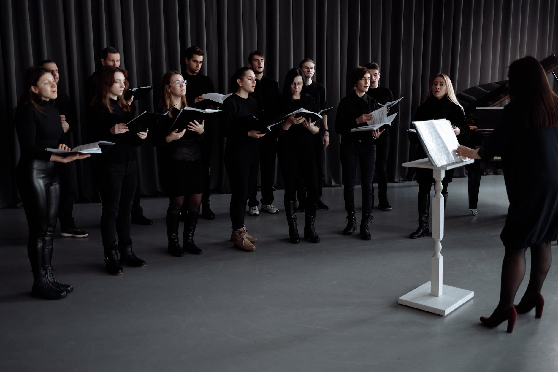 a choir wearing black clothes singing together
